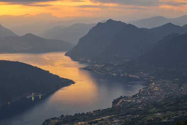 Elevated view of Sale Marasino illuminated at dusk, Iseo lake, Brescia, Lombardy, Italy, Southern Europe