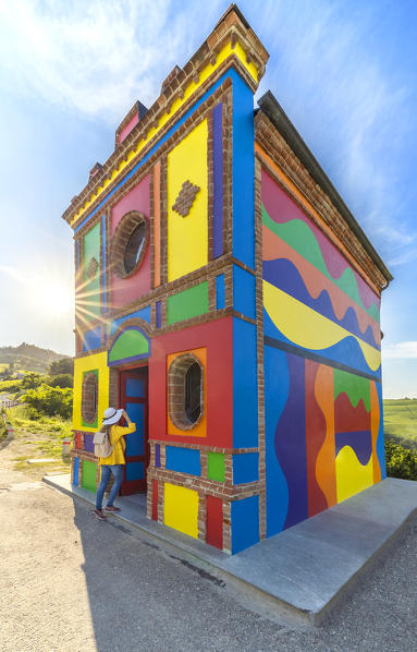 A woman observes Cappella del Barolo at sunset, La Morra, Cuneo, Langhe e Roero, Piedmont, Italy, Southern Europe (MR)