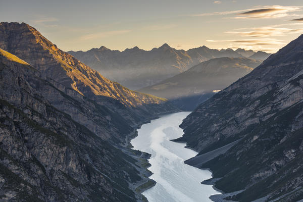 Elevated view from Crap del la Parè of Livigno lake and mountains that sourround it at sunset, Sondrio, Valtellina, Lombardy, Italy, Southern Europe