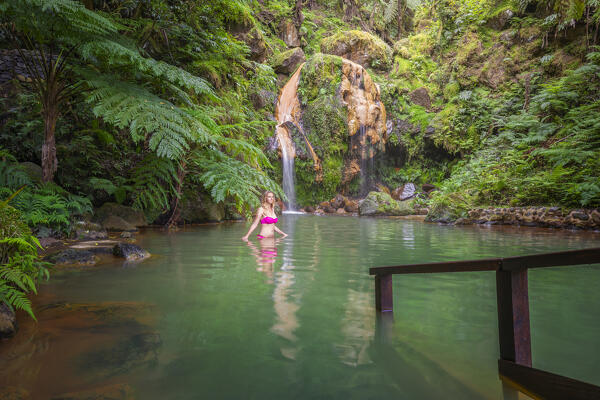 A woman in an hot springs of Caldeira Velha, Natural park, Ribeira Grande, Sao Miguel, Azores, Western Europe