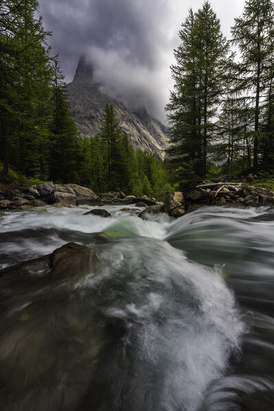 Cloudy morning at Dora di Veny river and Aiguille Noire de Peuterey during summer, Val Veny, La Visaille, Courmayeur, Valle D’Aosta, Italy, Southern Europe 