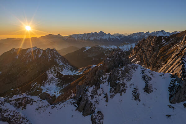 Aerial view of Pizzo Corzene and mountain range at sunset during winter, Castione della Pesolana, Prealpi Orobie, Bergamo, Lombardy, Italy, Southern Europe
