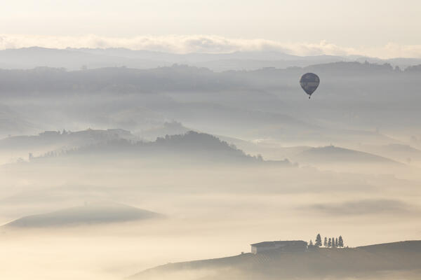 Vineyards around La Morra during autumn at sunrise and a Balloon, Cuneo, Langhe e Roero, Piedmont, Italy, Southern Europe