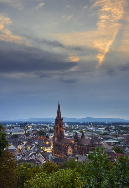 Elevated view of Illuminated Freiburg im Breisgau with its gothic cathedral from Schlossberg, Baden Wurttemberg, Germany, Deutschland, Western europe
