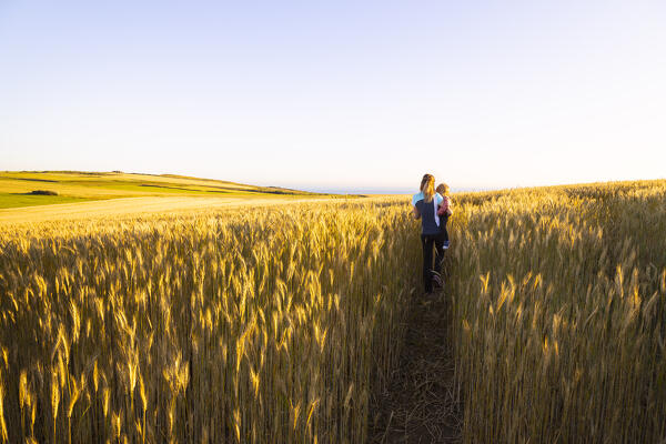 A woman and her daughter are walking during sunset at Cap Gris Nez , Audinghen, Boulogne sur Mer, Calais, Cote d’Opale, Haute France, France, Western Europe