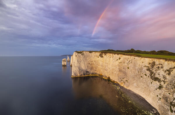 Rainbow at Sunrise at Old Harry Rocks during summer, Handfast Point, Purbeck isle, Dorset,  England, Great Britain, United Kingdom