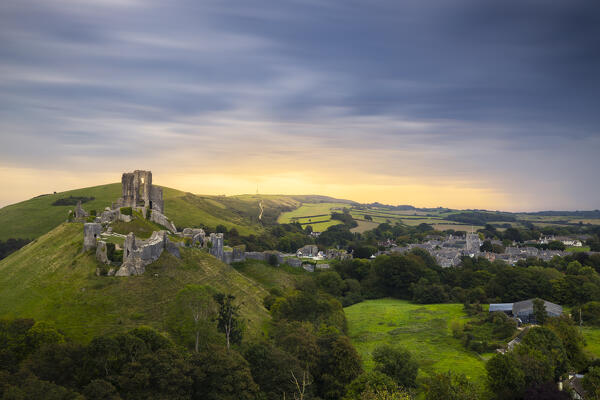 Corfe Castle portrayed from hills at sunrise, Corfe Castle, Purbeck, Dorset, England, Great Britain, United Kingdom