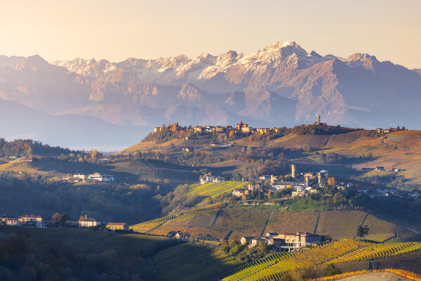 Castiglione Falletto and mountains in backgroung at sunrise during autumn, Cuneo, Langhe and Roero, Piedmont, Italy, Southern Europe