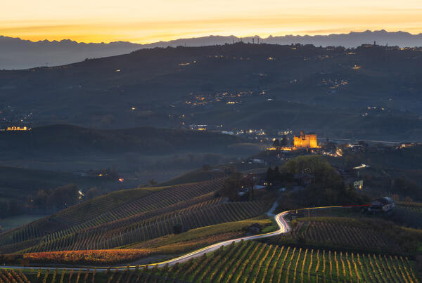 Illuminated Grinzane Cavour and trail lights of cars during  autumn, Cuneo, Langhe and Roero, Piedmont, Italy, Southern Europe