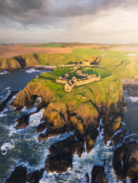 Aerial view of Dunnnottar Castle at sunrise, Stonehaven, Aberdeenshire, Scotland, United Kingdom