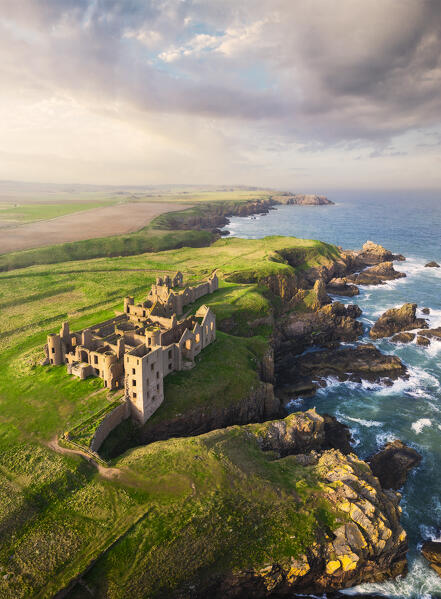 Aerial view of Slains Castle at sunset, Cruden Bay, Aberdeenshire, Scotland, United Kingdom