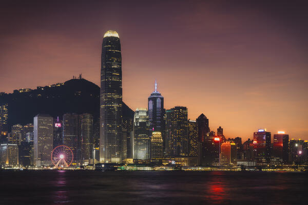 Illuminated cityscape during dusk viewed from Avenue of Stars, Tsim Sha Tsui, Kowloon, Hong Kong, China, Asia