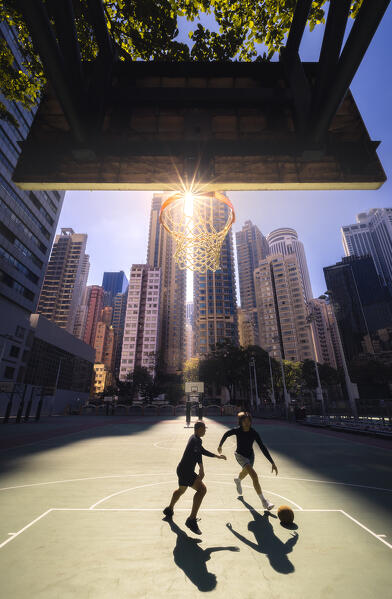 Two guys playing basketball in the middle of the buildings, Wan Chai, Hong Kong, China, Asia