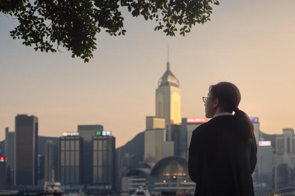 Woman observes cityscape during dusk viewed from Avenue of Stars, Tsim Sha Tsui, Kowloon, Hong Kong, China, Asia