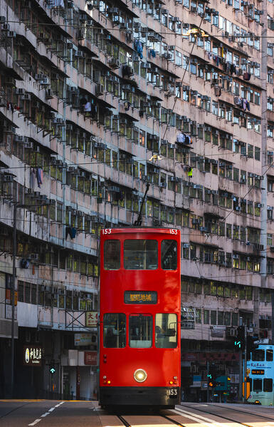 Red Tram in front of Monster Buildings, Quarry Bay. Hong Kong, China, Asia