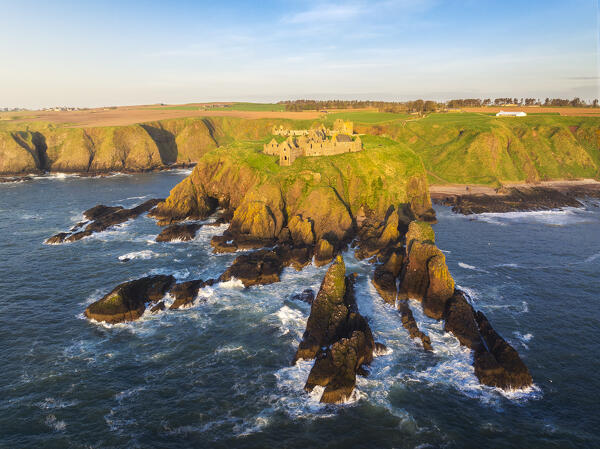 Aerial view of Dunnnottar Castle at sunrise, Stonehaven, Aberdeenshire, Scotland, United Kingdom