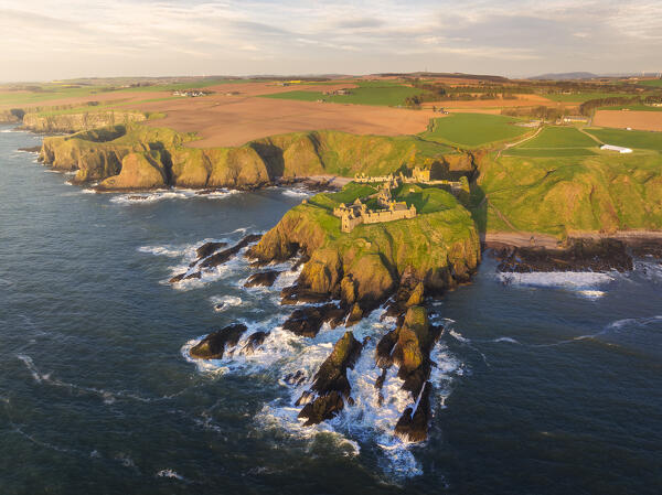 Aerial view of Dunnnottar Castle at sunrise, Stonehaven, Aberdeenshire, Scotland, United Kingdom