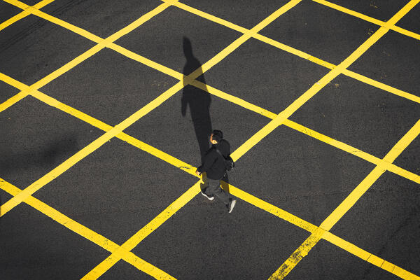 A man walks on pedrestian crossing, Central, Hong Kong, China, Asia