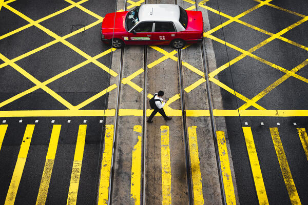 A man and a taxi on pedrestian crossing, Central, Hong Kong, China, Asia