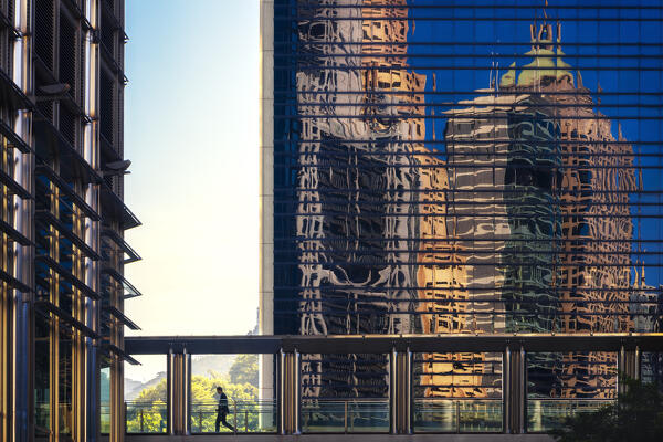 A person walks in Cheung Kong Centre, Central, Hong Kong island, Hong Kong, China, Asia