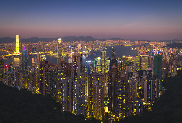 Elevated view of an illuminated Hong Kong cityscape viewed from Victoria Peak during twilight, The Peak, Hong Kong island, Hong Kong, China, Asia