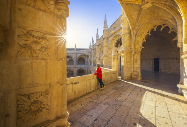 A tourist observes the Jeronimos Monastery during sunset from the cloister, Restelo, Belem, Lisbon, Portugal, Iberian peninsula, Western Europe