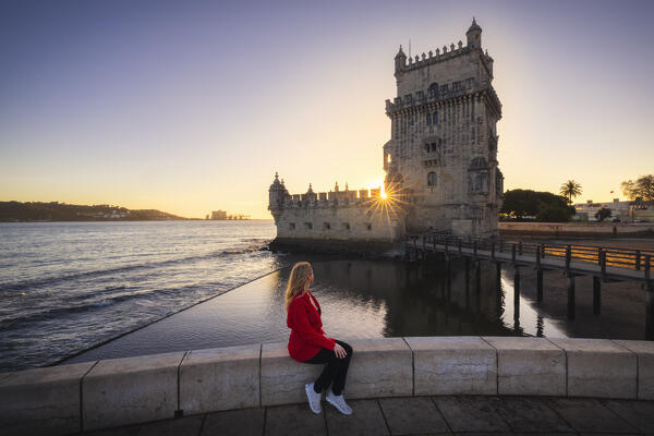 A tourist observes Belem Tower during sunset, Restelo, Belem, Lisbon, Portugal, Iberian peninsula, Western Europe