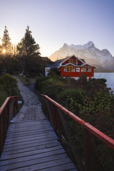 Lake Pehoe and Hosteria Pehoe with Mountains in the background during sunset, Torres del Paine NP, Ultima Esperanza, Region de Magallanes y de la Antartica Chilena, Patagonia, Chile, South America