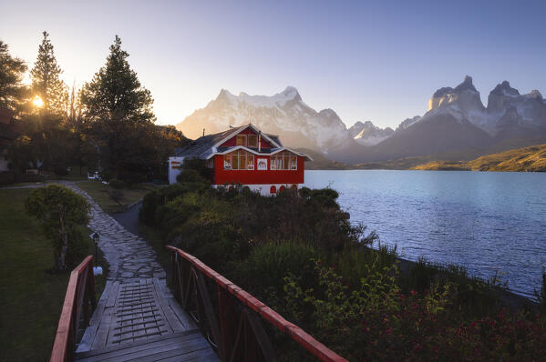 Lake Pehoe and Hosteria Pehoe with Mountains in the background during sunset, Torres del Paine NP, Ultima Esperanza, Region de Magallanes y de la Antartica Chilena, Patagonia, Chile, South America