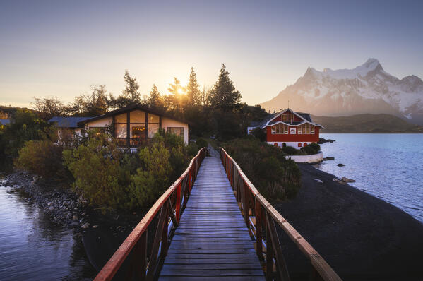 Lake Pehoe and Hosteria Pehoe with Mountains in the background during sunset, Torres del Paine NP, Ultima Esperanza, Region de Magallanes y de la Antartica Chilena, Patagonia, Chile, South America