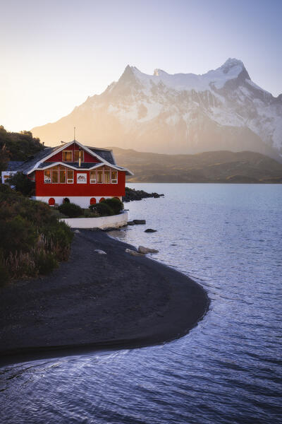 Lake Pehoe and Hosteria Pehoe with Mountains in the background during sunset, Torres del Paine NP, Ultima Esperanza, Region de Magallanes y de la Antartica Chilena, Patagonia, Chile, South America