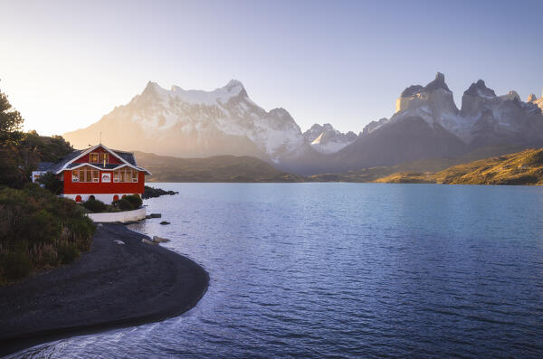 Lake Pehoe and Hosteria Pehoe with Mountains in the background during sunset, Torres del Paine NP, Ultima Esperanza, Region de Magallanes y de la Antartica Chilena, Patagonia, Chile, South America