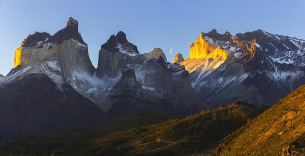 Panoramic view of Cuernos del Paine and moon during sunset, Torres del Paine NP, Ultima Esperanza, Region de Magallanes y de la Antartica Chilena, Patagonia, Chile, South America