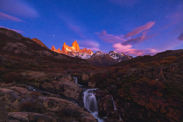 Escondida waterfall and Fitz Roy mountain in the background under a sky full of stars, El Chalten, Parque Nacional Los Glaciares, Santa Cruz, Patagonia Argentina, Argentina, South America
