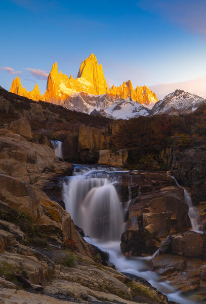 Escondida waterfall and Fitz Roy mountain in the background during sunrise, El Chalten, Parque Nacional Los Glaciares, Santa Cruz, Patagonia Argentina, Argentina, South America
