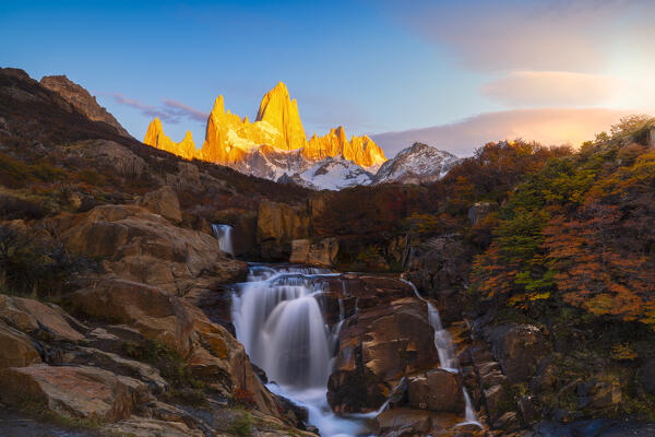 Escondida waterfall and Fitz Roy mountain in the background during sunrise, El Chalten, Parque Nacional Los Glaciares, Santa Cruz, Patagonia Argentina, Argentina, South America