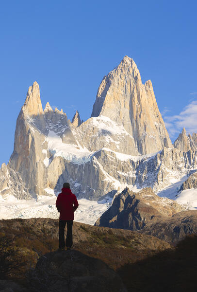 A tourist observes Fitz Roy mountain during sunrise, El Chalten, Parque Nacional Los Glaciares, Santa Cruz, Patagonia Argentina, Argentina, South America