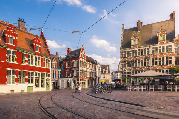 A tourist walks with her bike in Sint Veerplein square during sunset, Gand, Belgium, East Flanders, Flanders, Western Europe