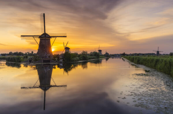 A group of windmills in Kinderdijk during sunset in summer, Molenlanden, Netherlands, South Holland, Western Europe