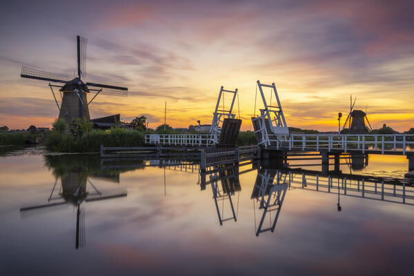 A windmill in Kinderdijk during sunset in summer, Molenlanden, Netherlands, South Holland, Western Europe
