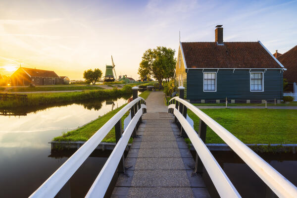 A wooden bridge and A typical house in Zaanse Schans during sunset in summer, Zaandam, Zaanstad, Netherlands, North Holland, Western Europe