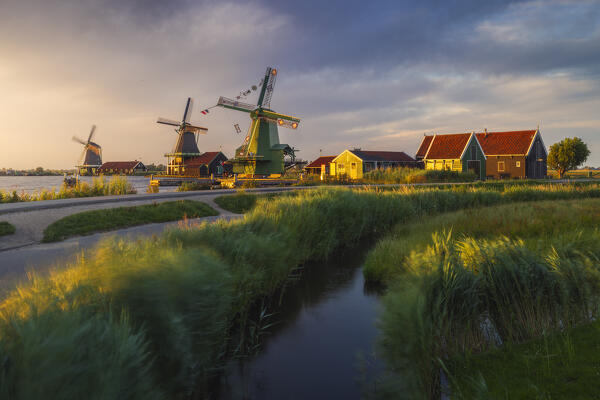 Windmills and typical houses in Zaanse Schans during sunset in summer, Zaandam, Zaanstad, Netherlands, North Holland, Western Europe