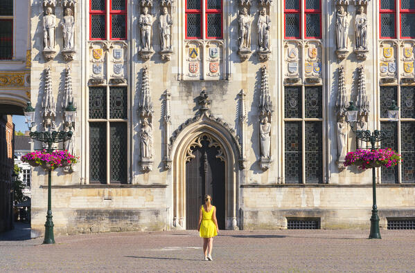 A tourist in front of Town Hall of Bruges, Bruges, Belgium, West Flanders, Flanders, Western Europe