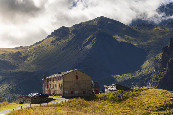 View of the shelter Pian del Re surrounded by mountains during sunrise, Pian del Re, Crissolo, Cuneo, Piedmont, Italy, Southern Europe