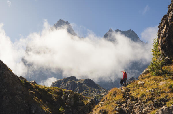 A woman points out Monviso to her daughter during sunrise near lake Fiorenza, Crissolo, Cuneo, Piedmont, Italy, Southern Europe