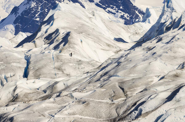 A tourist walks over Perito Moreno glacier, Parque Nacional Los Glaciares, El Calafate, Santa Cruz, chilean antarctica region, Patagonia Argentina, Argentina, South America