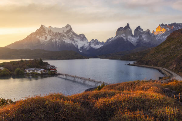 Elevated view of Lake Pehoe and Hosteria Pehoe with Mountains in the background during sunset, Torres del Paine NP, Ultima Esperanza, Region de Magallanes y de la Antartica Chilena, Patagonia, Chile, South America