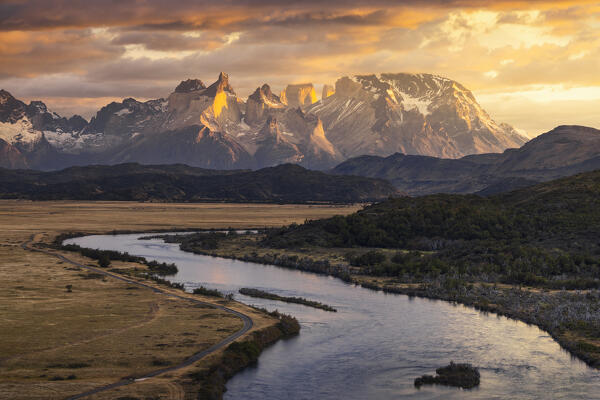 Elevated view of Cuernos del Paine during sunrise and a river, Torres del Paine NP, Ultima Esperanza, Region de Magallanes y de la Antartica Chilena, Patagonia, Chile, South America
