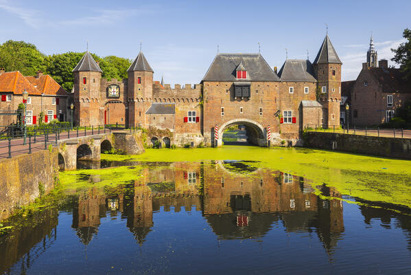 Koppelpoort and its reflection in Eem river during summer at sunset, Amersfoort, Netherlands, Utrecht, Western Europe