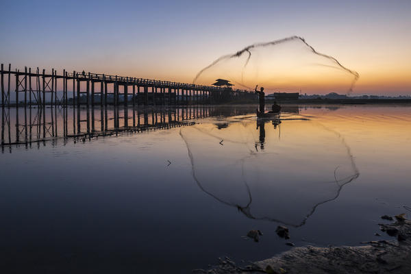Fisherman at U-Bein Bridge at sunrise,Amarapura, Mandalay, Myanmar, Southeast Asia  